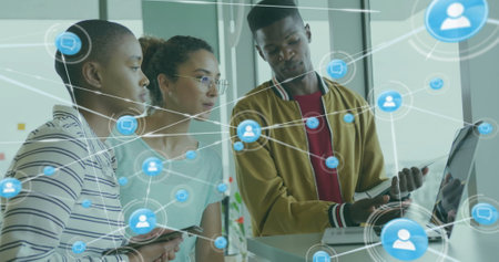Image of network of connections with people icons over diverse business people in office. Global finance, business, connections, computing and data processing concept digitally generated image.の写真素材