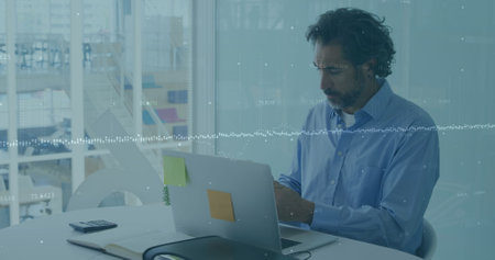 Financial data processing over caucasian man working on laptop in office. frances, global business,...