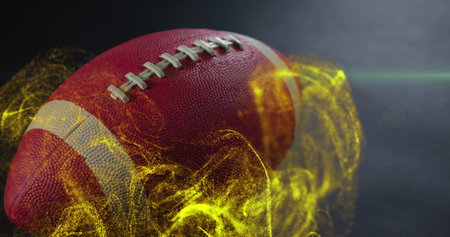 Image of moving lens flare and abstract pattern over rugby ball on gray ground. Digital composite, multiple exposure, illuminated, sports and competition concept.の写真素材