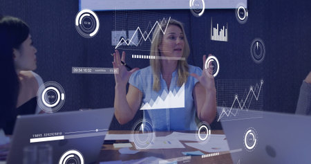 Image of data processing over diverse business people in office. Global finance, business, connections, computing and data processing concept digitally generated image.の写真素材