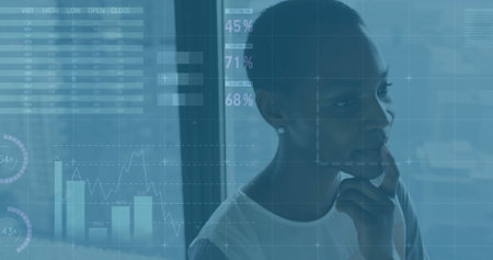Image of financial data processing over african american businesswoman in office. Global finance,...