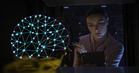 Image of brain network and caucasian businesswoman using tablet on dark background. Connection, network, data, digital interface and communication, digitally generated image.の写真素材