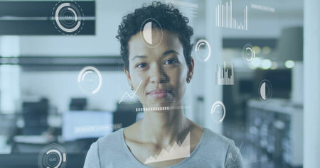 Businesswoman in office with data analytics and charts image. technology, corporate, finance,...