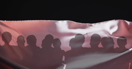 Image of silhouettes of people and floating cloth on black background. Abstraction and lifestyle, digitally generated image.の写真素材