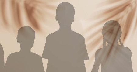 Image of silhouettes of children and palm tree shadow on beige background. Abstraction and lifestyle, digitally generated image.の写真素材