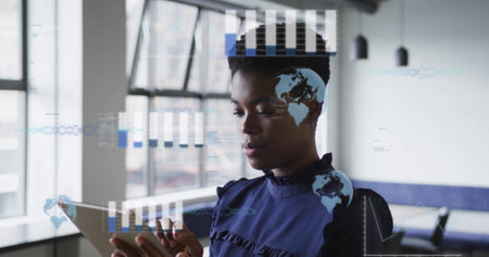 Image of financial data processing over afrcian american businesswoman using tablet. Global finance, business, connections, computing and data processing concept digitally generated image.の写真素材