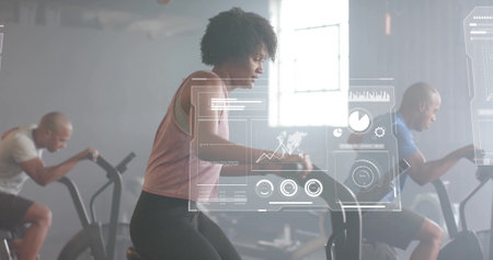 Image of financial data processing over diverse people using elliptical bikes on gym. Global...