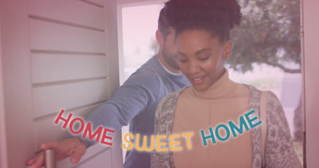 Image of home sweet home text with light spots over diverse couple walking through door. Lifestyle, communication and domestic life concept digitally generated image.の写真素材
