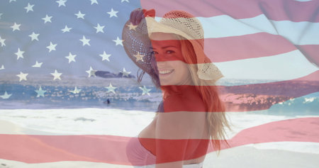 Image of flag of usa over caucasian woman on beach in summer. Usa, american patriotism, national flag and lifestyle concept digitally generated image.の写真素材