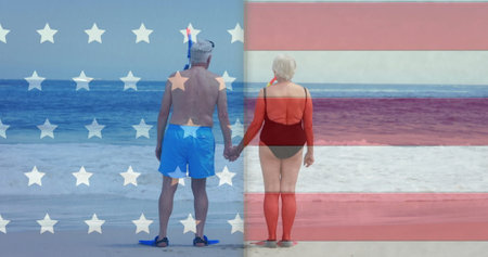 Image of flag of usa over caucasian senior couple on beach in summer. Usa, american diversity, national flag and patriotism concept digitally generated image.の写真素材