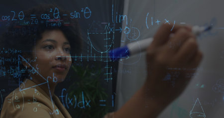 Image of mathematical equations over african american businesswoman taking notes. global networks, business, data processing and digital interface concept digitally generated image.の写真素材