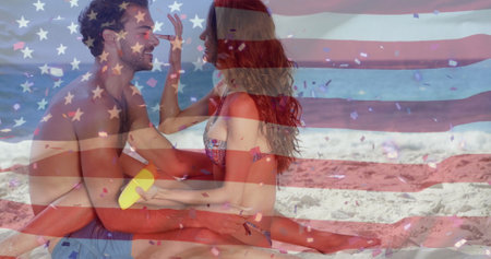 Image of flag of usa over caucasian couple on beach in summer. Usa, american patriotism, national flag and lifestyle concept digitally generated image.の写真素材