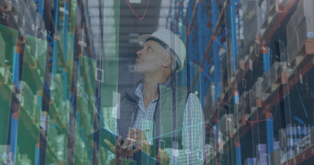 Image of statistics and financial data processing over man working in warehouse. global shipping and connections concept digitally generated image.の写真素材