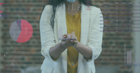 Asian woman holding smartphone, analyzing data on screen. She has long black hair, wearing yellow...