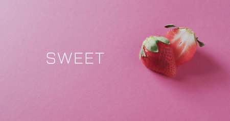 Image of sweet text over halved strawberry on pink background. Fruit, healthy diet and vegan fresh food concept digitally generated image.の写真素材