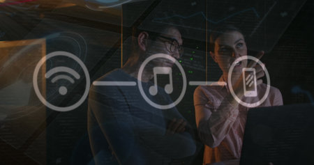 Image of icons over diverse couple of server room workers. Cloud computing concept concept digitally generated image.の写真素材