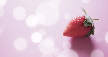 Composition of strawberry and white spots on pink background. Fruit, vegetarian food and organic healthy produce concept.の写真素材