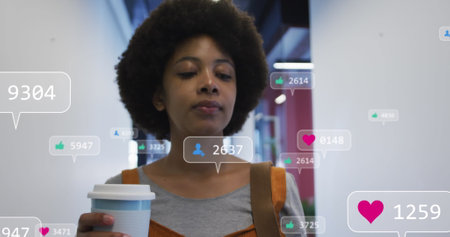 Image of media icons over african american businesswoman drinking coffee and smiling. global networks, business, data processing and digital interface concept digitally generated image.の写真素材