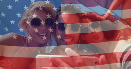Image of flag of usa over diverse friends on beach in summer. Usa, american diversity, national flag and patriotism concept digitally generated image.の写真素材