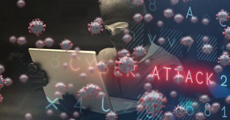 Digital illustration of macro Covid-19 cells floating with red words Cyber Attack over a man wearing a balaclava using a laptop. Coronavirus Covid-19 pandemic concept digital compositeの写真素材