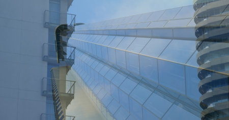 Image of moving modern buildings in city with blue sky in the background 4k