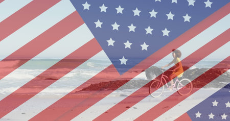Image of american flag revealing statue of liberty and woman riding bike on beach. usa patriotism, celebration and democracy concept digitally generated image.の写真素材