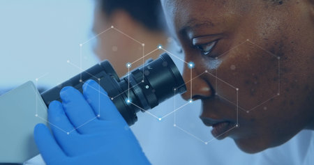 Image of network of connections over african american female scientist working in lab. Global...