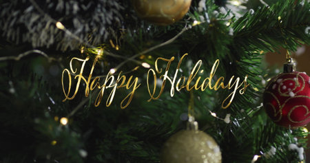 Image of happy holidays text over christmas tree. Christmas and celebration concept, digitally generated image.の写真素材