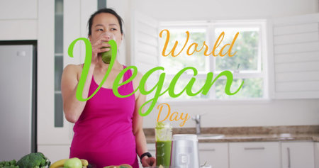 Image of world vegan day text over asian woman drinking healthy drink. Global ecology and digital interface concept digitally generated image.の写真素材