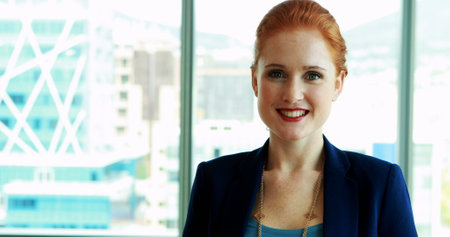 Portrait of smiling female executive in officeの写真素材