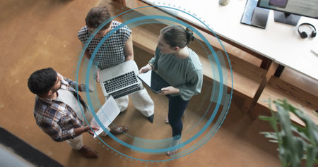 Image of digital icon and data processing over diverse business people in office. Global finance, business, connections, computing and data processing concept digitally generated image.の写真素材