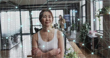 Image of connections and data processing over asian businesswoman in office. Global finance, business, connections, computing and data processing concept digitally generated image.の写真素材