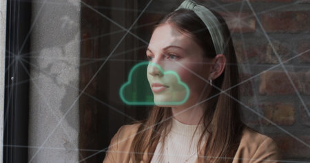 Image of cloud and data processing over caucasian businesswoman in office. Global finance, business, connections, cloud computing and data processing concept digitally generated image.の写真素材