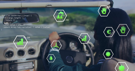 Image of eco icons over biracial woman driving car. Global green energy, environment, connections, computing and data processing concept digitally generated image.の写真素材