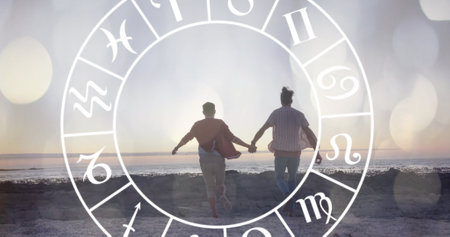 Image of horoscope over happy biracial couple holding hands at beach. Lifestyle, nature, horoscope...