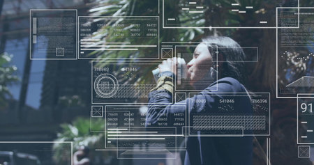 Image of data processing over biracial woman drinking takeaway coffee. Business, social media and digital interface concept digitally generated image.の写真素材