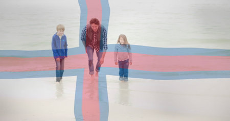 Father and daughter playing on beach, Faroe Islands flag over image. Family, bonding, vacation, playful, fun, waterの写真素材