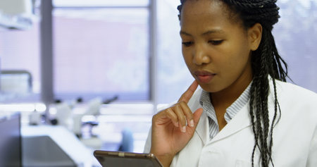 Beautiful scientist using digital tablet in laboratoryの写真素材