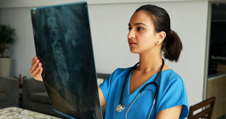 Female doctor examining x-ray in hospital