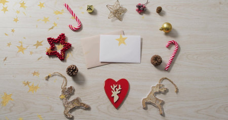 Christmas decorations with cards over star image on wooden background. holiday, greeting cards, festive, celebratory, winter, seasonalの写真素材