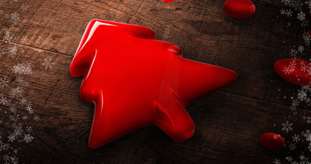 Image of red christmas tree over wooden background. Christmas, tradition and celebration concept digitally generated image.の写真素材