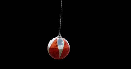 Image of christmas red bauble on black background. Christmas, tradition and celebration concept...