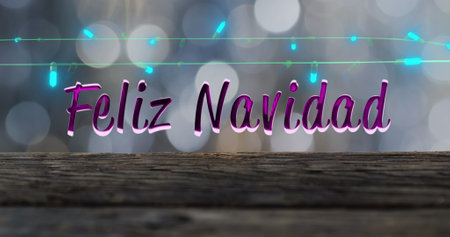 Image of feliz navidad text and fairy lights on wooden and lights background. Christmas, tradition and celebration concept digitally generated image.の写真素材