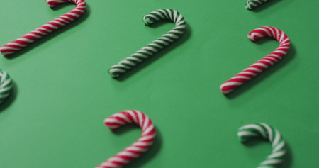 Image of merry christmas text over candy canes. Christmas, celebration and digital interface concept digitally generated image.の写真素材