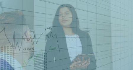 Image of financial data processing over diverse colleagues having meeting in office. Global business, finances and digital interface concept digitally generated image.の写真素材