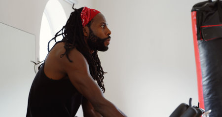 Side view of male boxer exercising in fitness studioの写真素材