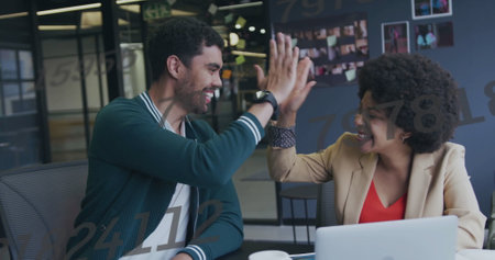 Image of data processing over biracial colleagues discussing work. Business, technology and digital interface concept digitally generated image.の写真素材