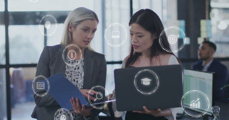 Image of business icons over diverse colleagues discussing work in office. Business, technology and...