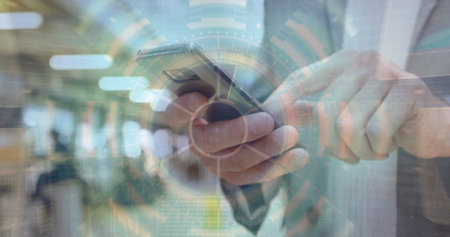 Image of financial data processing over caucasian businessman using smartphone. Global finance, business, connections, computing and data processing concept digitally generated image.の写真素材