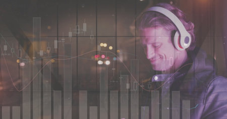 Image of diagrams over caucasian man listening to music. Music, technology and digital interface concept digitally generated image.の写真素材